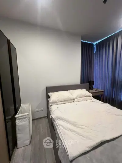 Cozy bedroom with modern decor and ample natural light