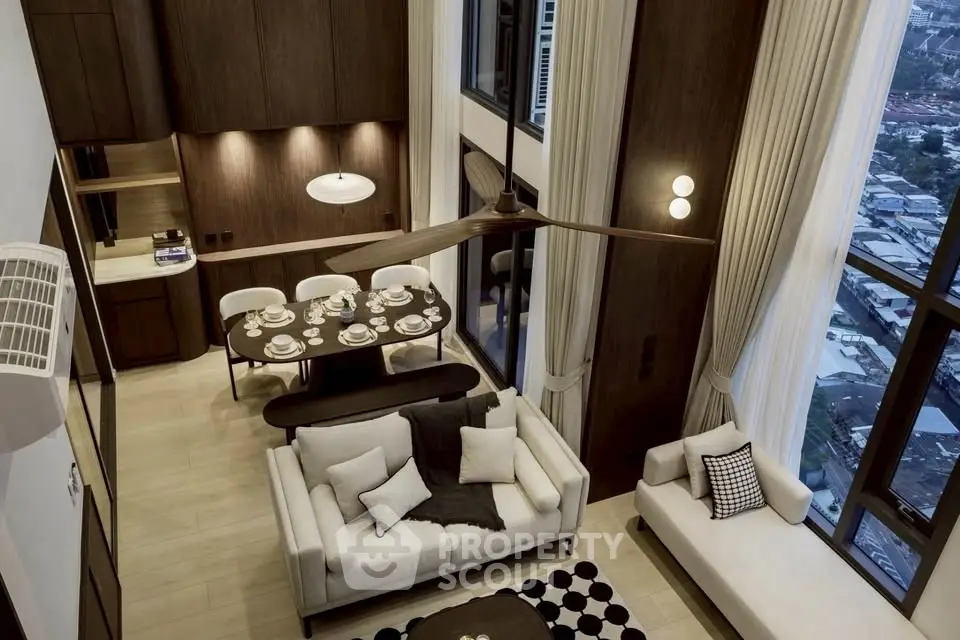 Luxurious high-ceiling living room with elegant dining area and city view