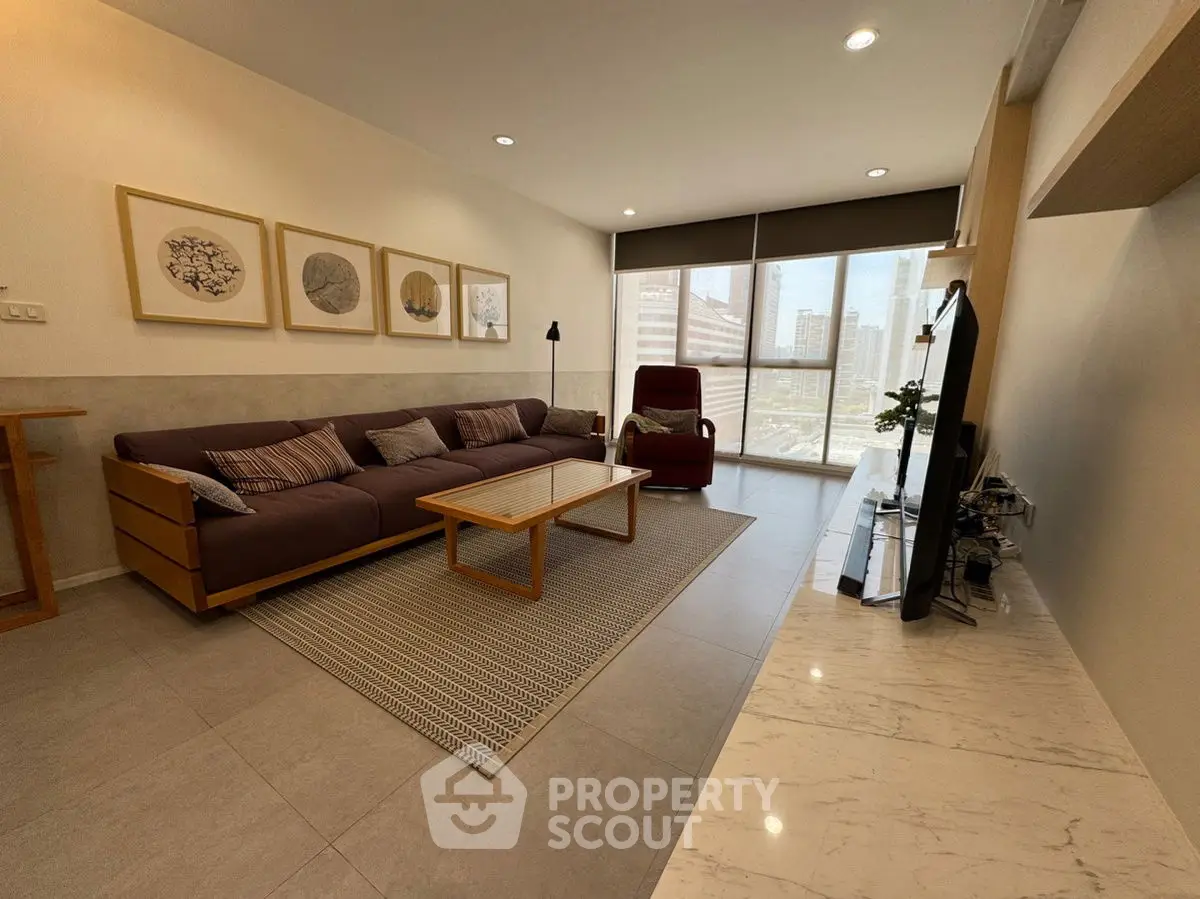 Spacious modern living room with stylish decor and city view, perfect for relaxation.