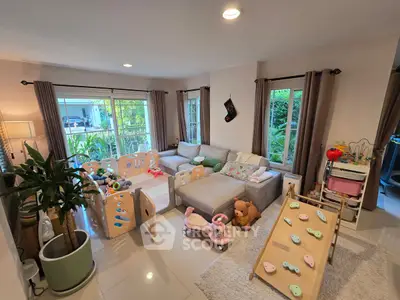 Charming family living room with play area and cozy seating, perfect for relaxation and family time.