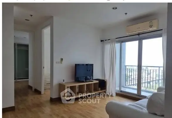 Modern living room with balcony view and natural light