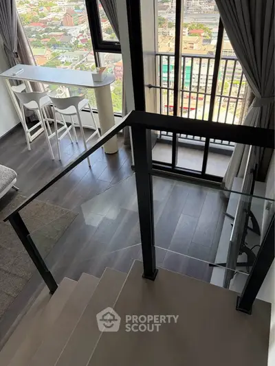 Modern duplex apartment with city view, featuring stylish interior and floor-to-ceiling windows.