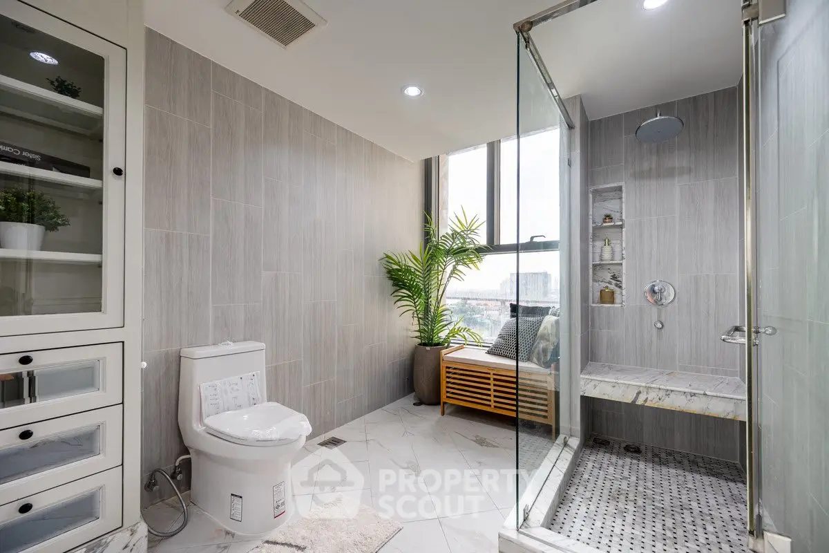 Luxurious bathroom with glass shower and modern fixtures