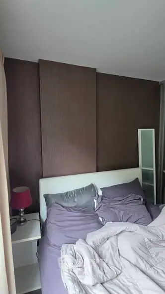 Cozy bedroom with modern decor and plush bedding, perfect for relaxation.