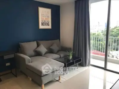 Modern living room with stylish gray sofa and balcony view