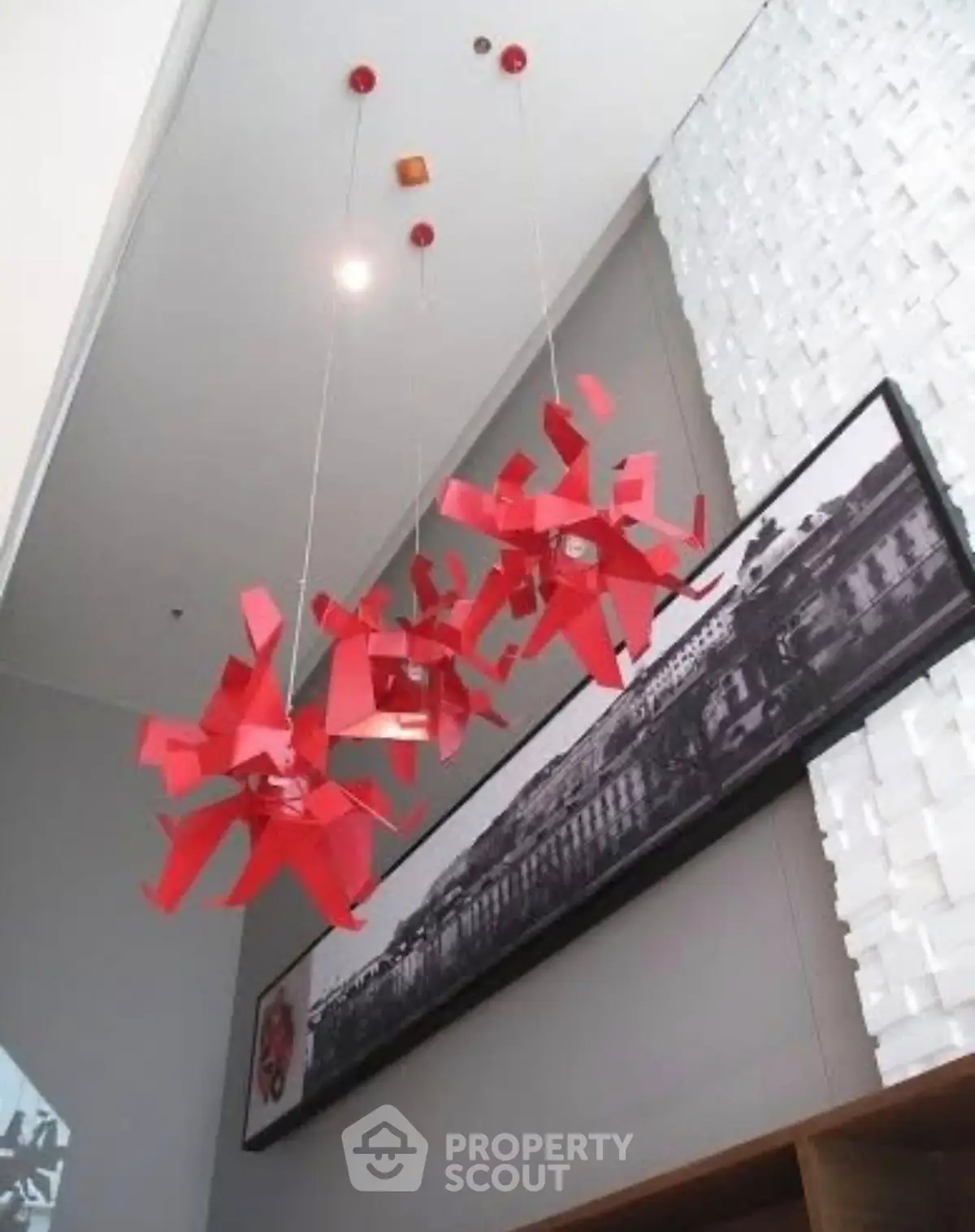 Modern interior with unique red pendant lights and artistic wall decor