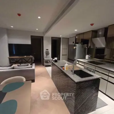 Modern open-layout kitchen and living room with sleek design and high-end appliances.
