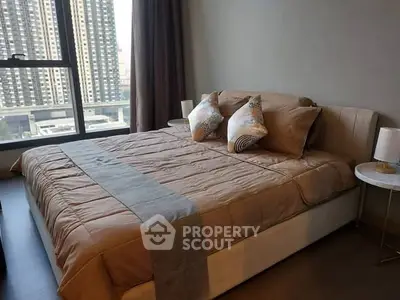 Luxurious bedroom with city view and elegant decor in modern apartment.