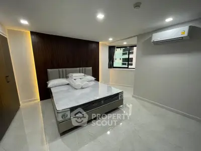 Modern bedroom with sleek design, featuring a stylish bed and air conditioning, perfect for comfort and relaxation.