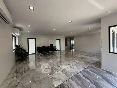 Spacious modern office space with marble flooring and ample natural light