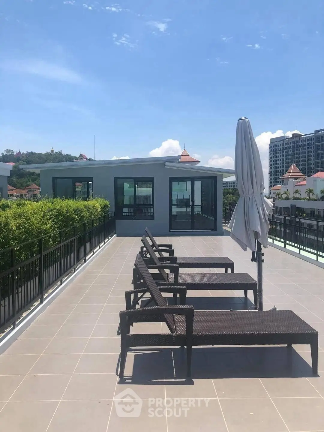 Spacious rooftop terrace with lounge chairs and scenic view