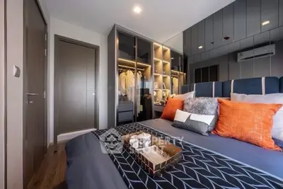 Luxurious modern bedroom with stylish decor and mirrored wardrobe