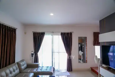 Spacious living room with modern decor and large windows for natural light.