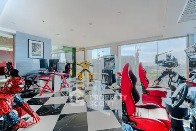 Luxurious gaming-themed living room with panoramic city views and modern decor.