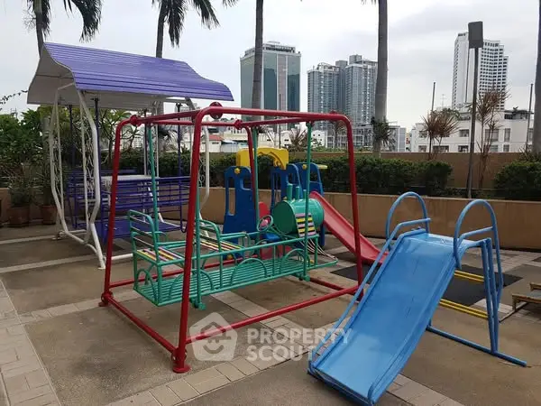 Vibrant playground area in urban residential complex with skyline view