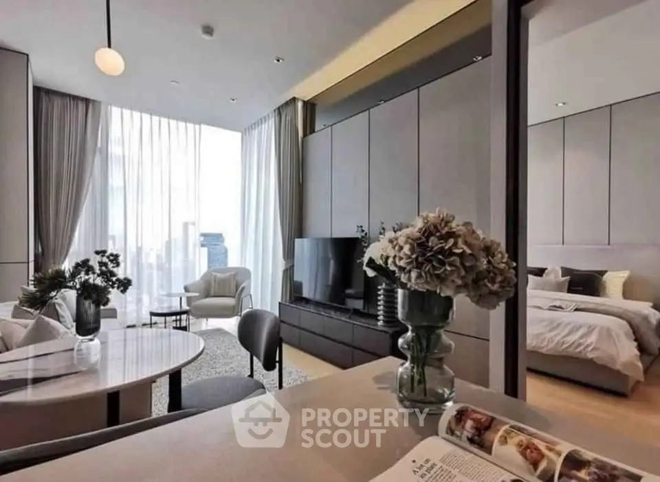 Luxurious modern living room with open layout and elegant bedroom view, featuring chic decor and floor-to-ceiling windows.