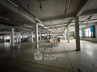 Spacious industrial warehouse with open layout and ample natural light.