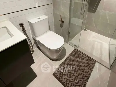 Modern bathroom with sleek fixtures and glass shower enclosure