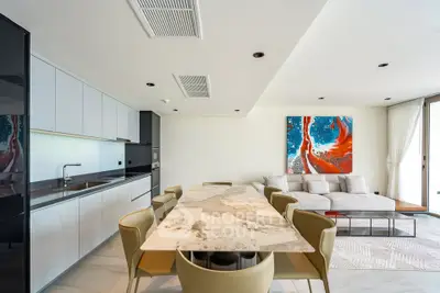 Modern open-plan living room and kitchen with stylish decor and elegant furniture.