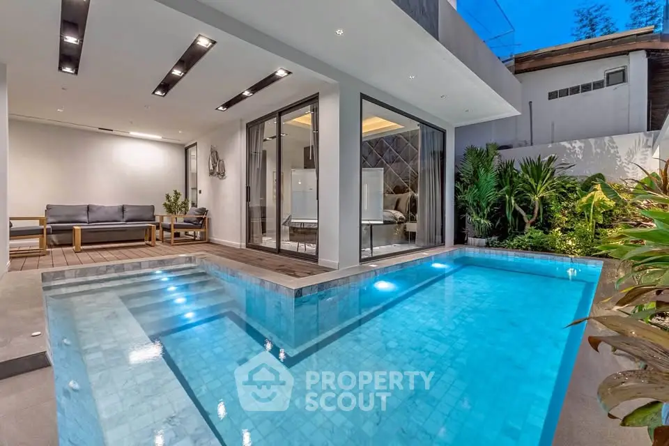 Luxurious modern home with private pool and stylish outdoor seating area.