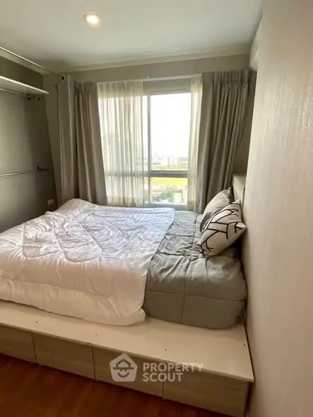 Cozy bedroom with large window and stylish decor in modern apartment