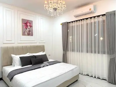 Luxurious bedroom with elegant chandelier and modern decor