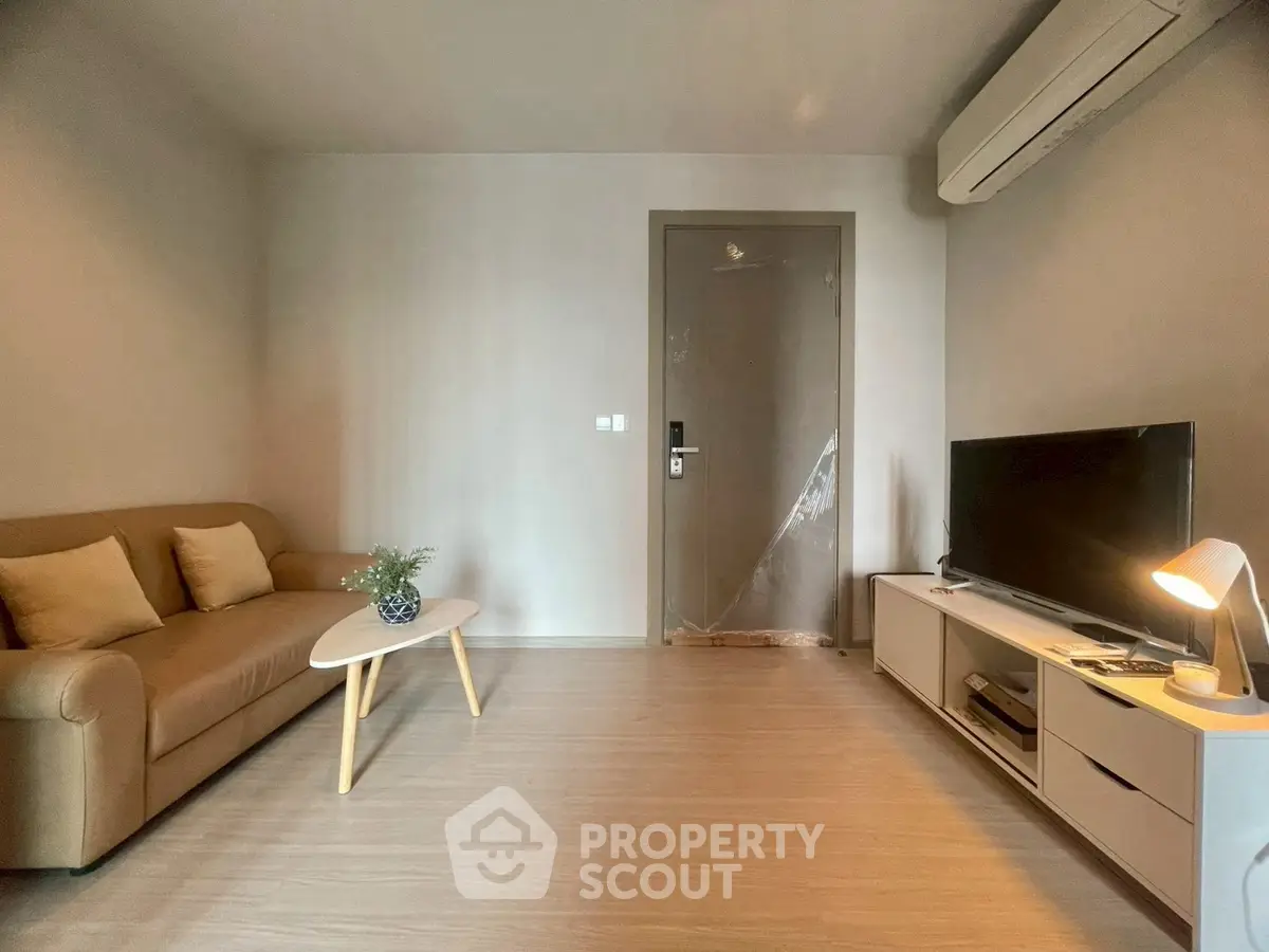 Modern living room with cozy sofa, stylish coffee table, and sleek TV setup.