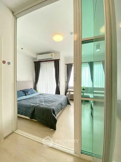 Modern bedroom with glass sliding doors and natural light