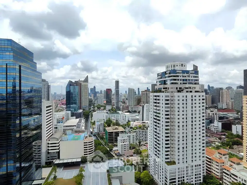 Stunning cityscape view from a high-rise building showcasing urban skyline and modern architecture.