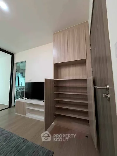 Modern living room with built-in storage and TV unit, showcasing sleek design and functionality.