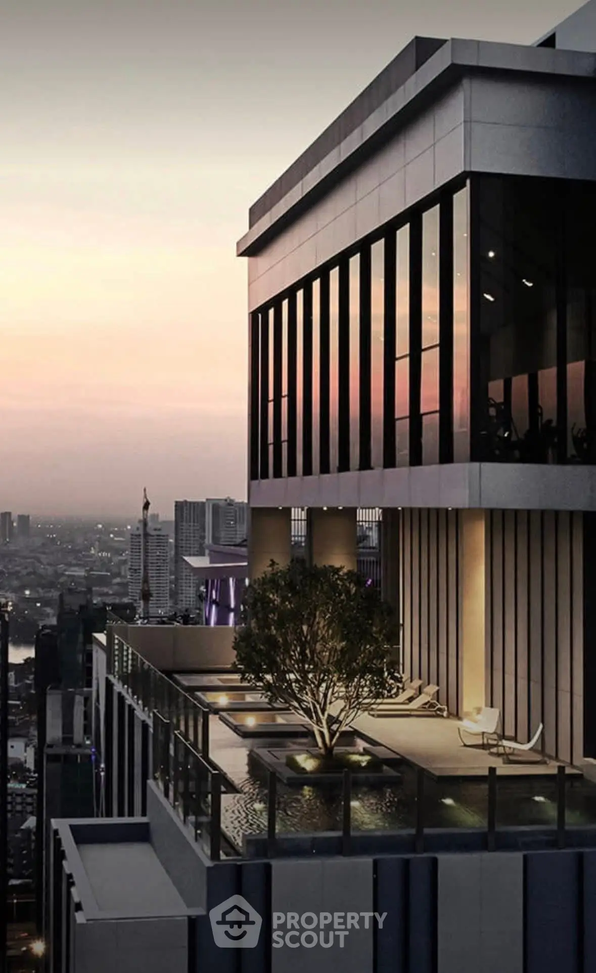 Luxury high-rise building with stunning sunset view and modern balcony pool.