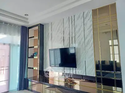 Luxurious living room with modern TV setup and elegant marble wall design