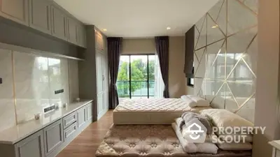 Luxurious bedroom with modern design and large window offering scenic views