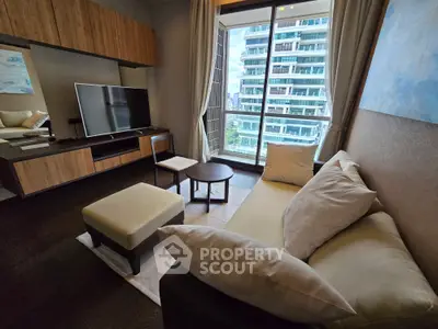 Modern living room with large TV and balcony view in luxury apartment