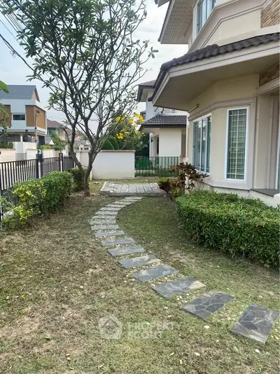 Charming suburban home with lush garden and stone pathway, perfect for family living.