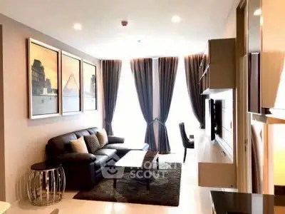 Modern living room with elegant decor and large windows in a stylish apartment.