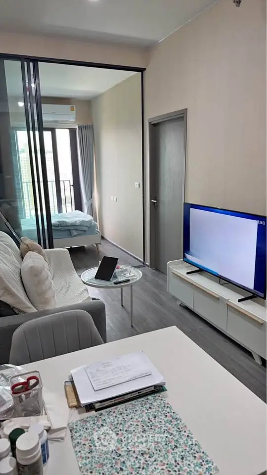 Modern apartment interior with cozy living area and bedroom view