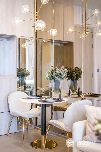 Luxurious modern dining area with elegant lighting and mirrored accents