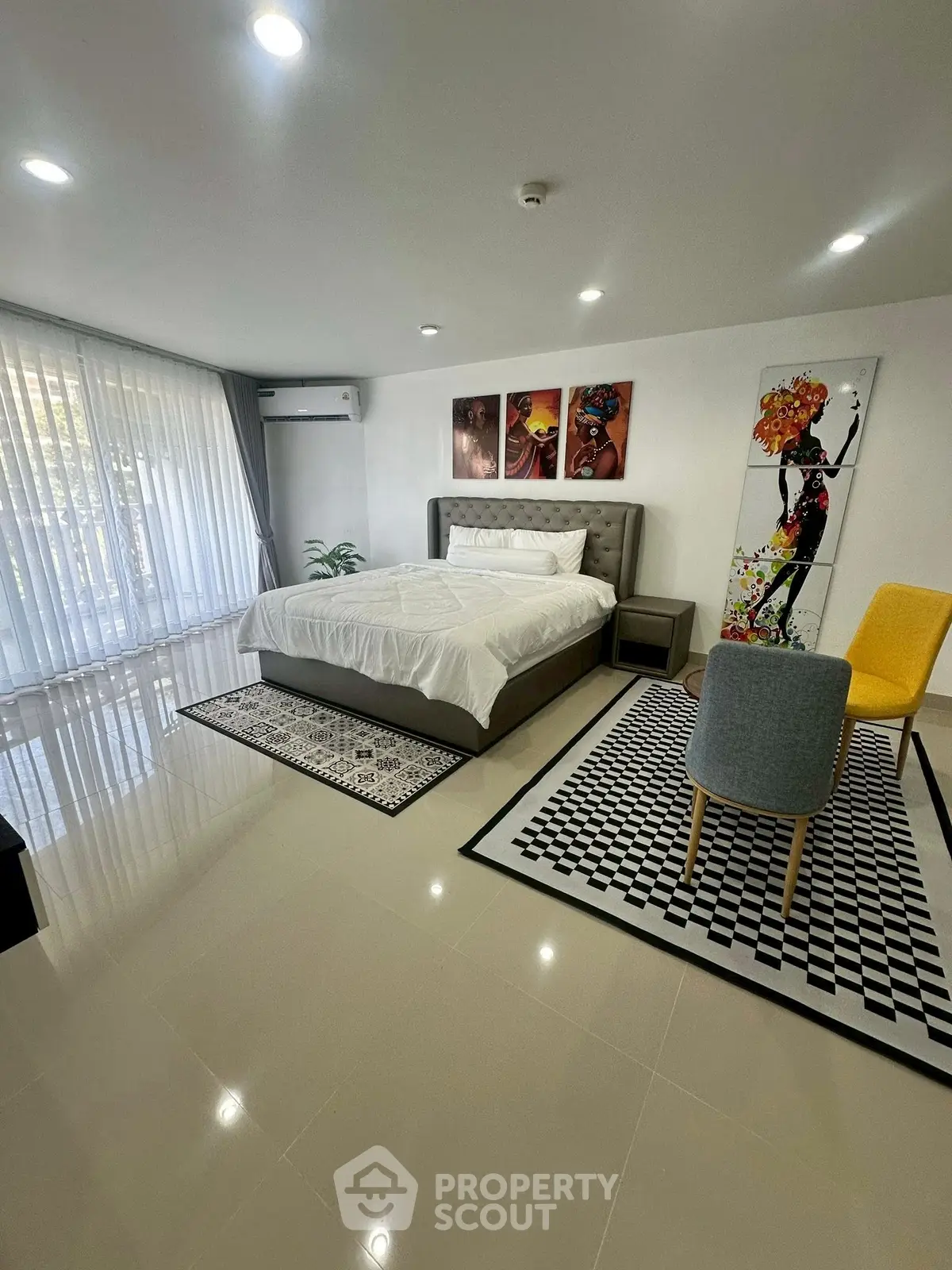 Spacious modern bedroom with stylish decor and natural light