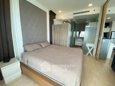 Modern bedroom with stylish decor and ensuite bathroom in a luxury apartment.