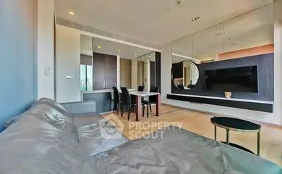 Modern living room with sleek furniture and large mirror wall