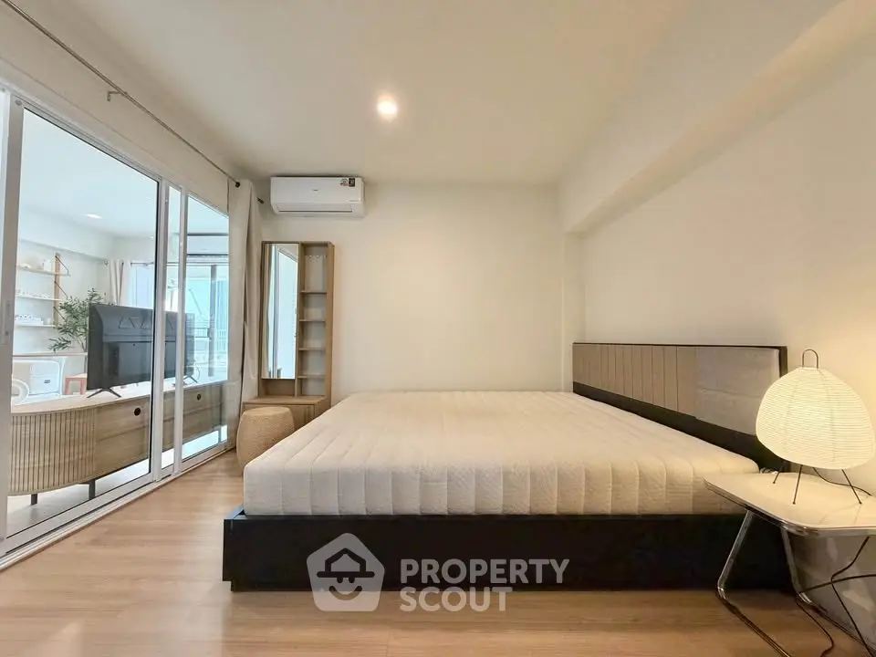 Spacious modern bedroom with minimalist decor and natural light