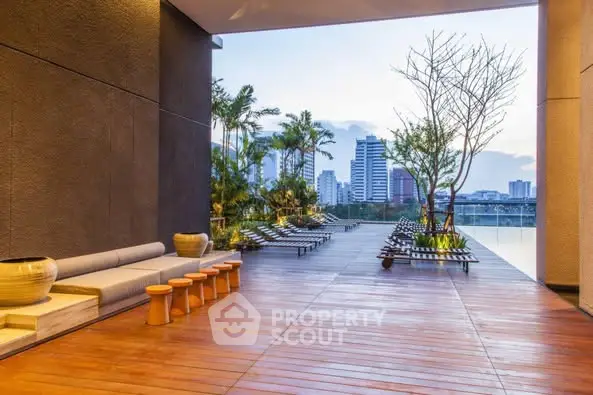 Luxurious rooftop terrace with stunning city view and modern lounge chairs.
