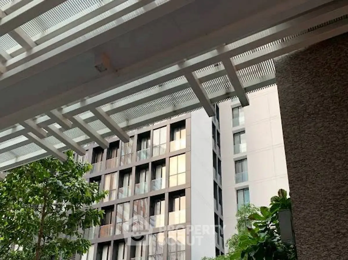 Modern building exterior with sleek design and lush greenery