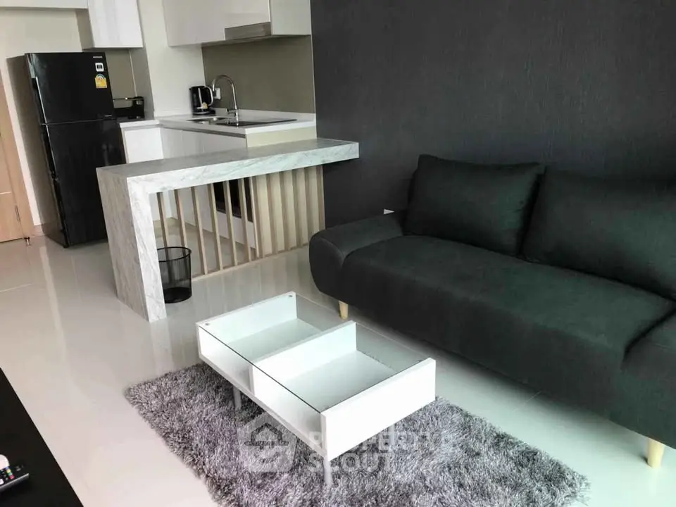 Modern living room with sleek furniture and open kitchen layout