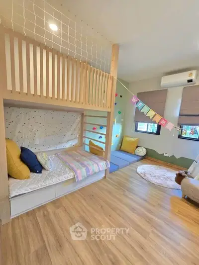 Charming children's bedroom with bunk bed and play area, perfect for family living.