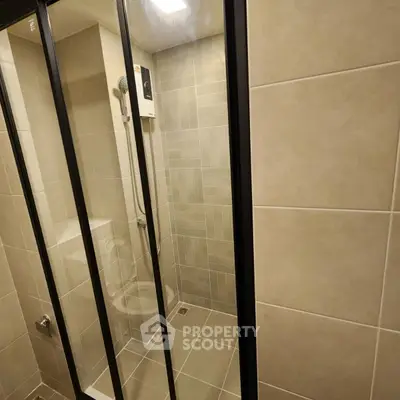 Modern bathroom with glass shower doors and sleek tile design