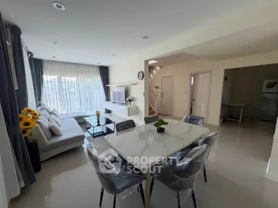 Spacious modern living room with dining area and natural light