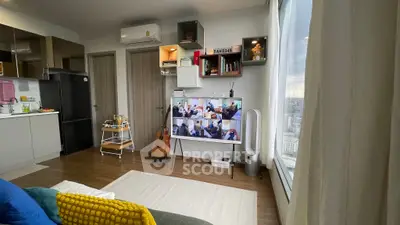 Modern living room with large window view, stylish decor, and open kitchen layout.