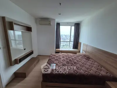Modern bedroom with city view, featuring a cozy bed and stylish wooden furniture.